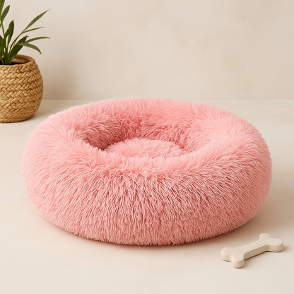 A plush circular pink calming donut bed for dogs and cats with a soft fluffy texture for comfort and relaxation