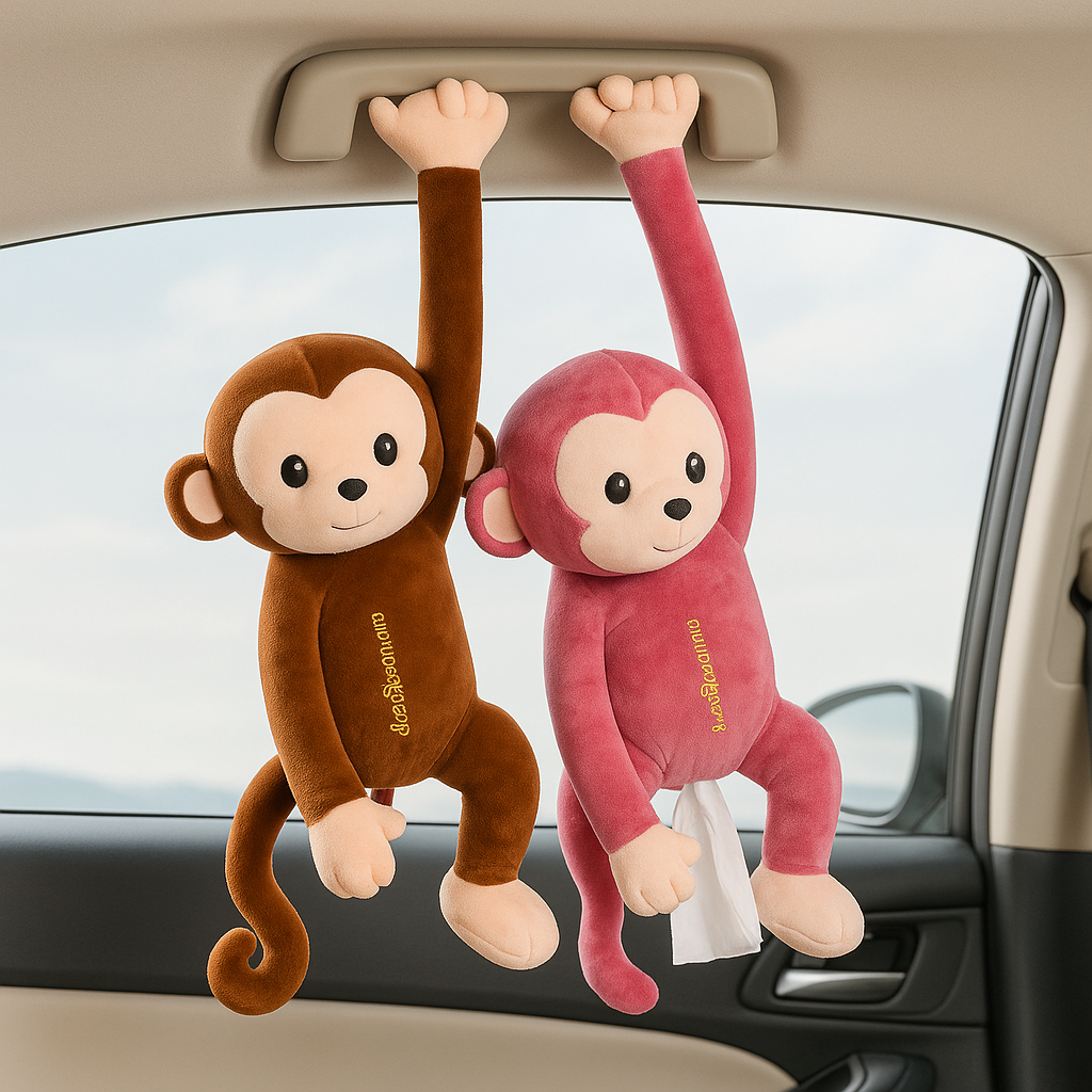 Two plush monkeys in brown and pink hanging from a car ceiling handle as a hanging monkey tissue holder