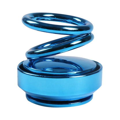 A sleek glossy blue metallic coiled spring car air freshener with a circular base for auto rotation use