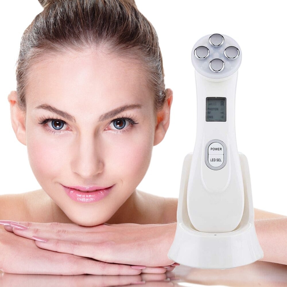 White 5-in-1 face massager device with four circular treatment heads and digital display for facial massage therapy