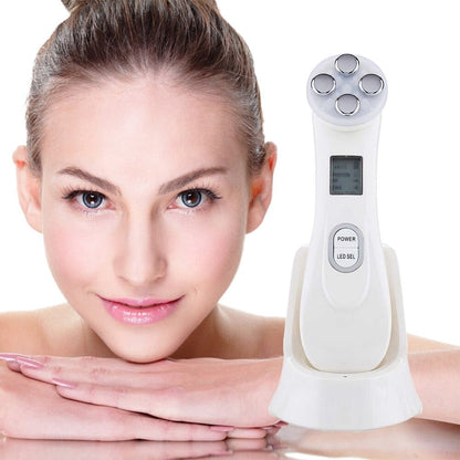 White 5-in-1 face massager device with four circular treatment heads and digital display for facial massage therapy