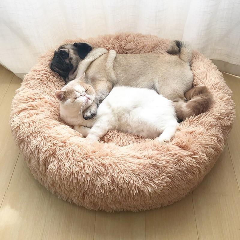 Soft plush beige calming donut bed for dogs and cats with a cozy fluffy texture for pet comfort