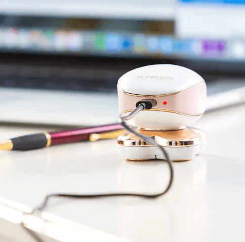 Rose gold and white wireless charging pad with sleek rounded design for flawless leg hair remover for women
