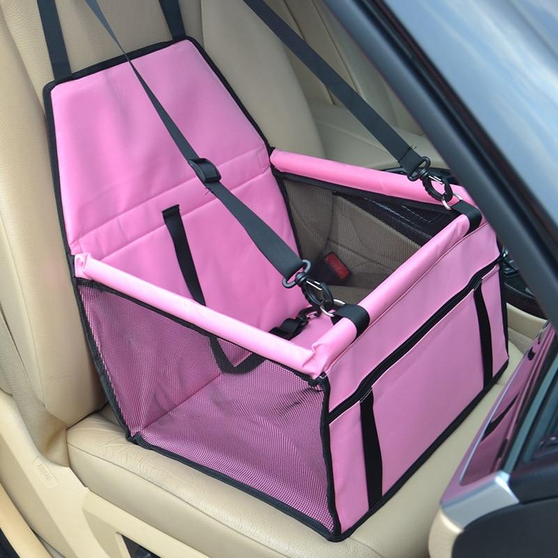 Pink pet car seat with black mesh panels and adjustable straps designed for dog travel car seat carrier use