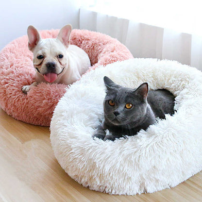 Soft plush pink and white calming donut bed for dogs and cats with fluffy shaggy texture for comfort and relaxation