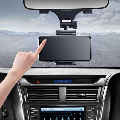 Black smartphone mounted on a 360° rearview mirror phone holder attached to a car dashboard holder
