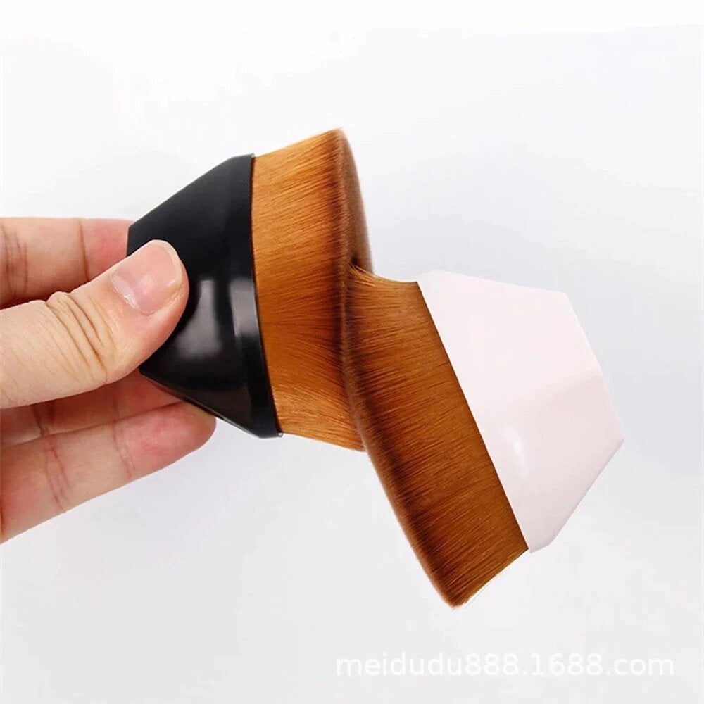 A high density foundation brush with a sleek black and white hexagonal handle and dense golden-brown bristles