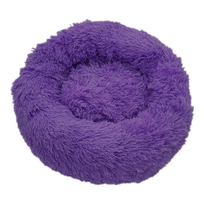 Purple fluffy calming donut bed for dogs and cats with soft plush texture and circular design