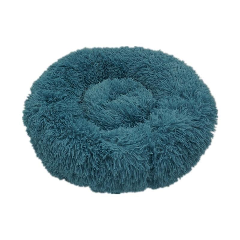 Teal plush circular calming donut bed for dogs and cats with soft fluffy texture for comfort and relaxation
