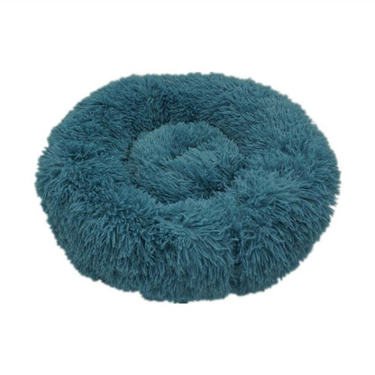 Teal plush circular calming donut bed for dogs and cats with soft fluffy texture for comfort and relaxation