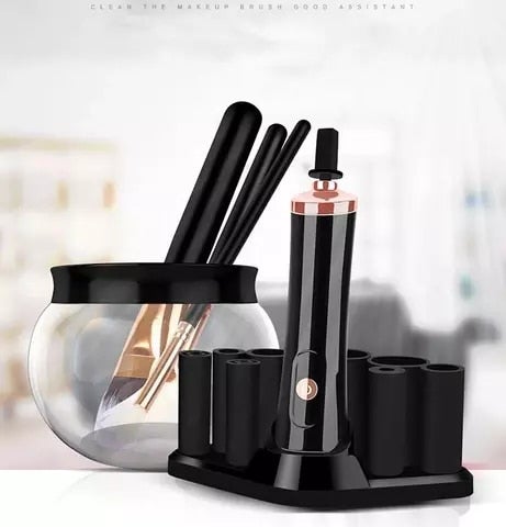 Black electric makeup brush cleaner and dryer with rose gold accents and matching black cylindrical holders