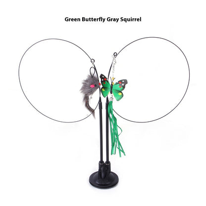 Green butterfly and gray squirrel cat sucker teaser toy with dangling feathers on a black stand for playtime