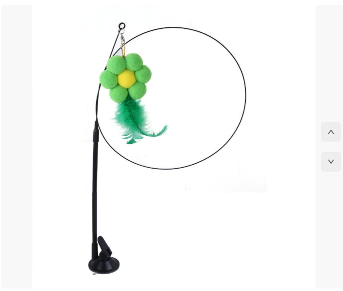 Cat sucker teaser toy with green and yellow plush flower and green feather on black circular adjustable stand