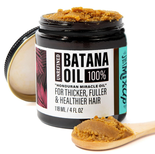 A jar of unrefined dark amber batana oil in a black glass container with a white label for glow restore hair mask