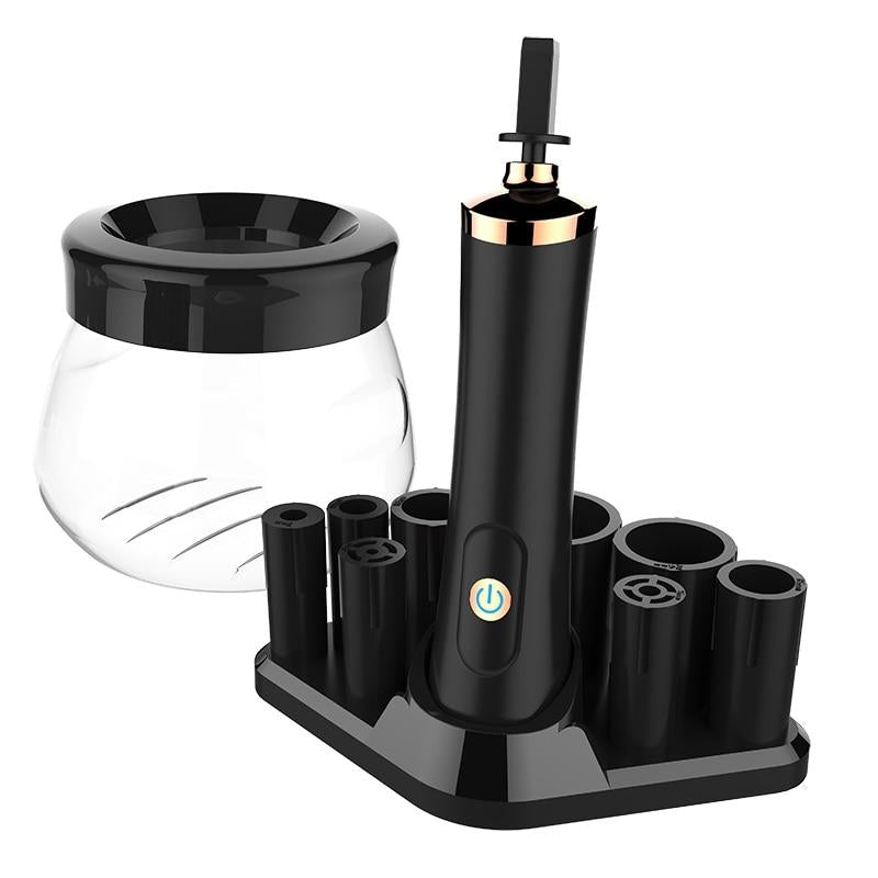 Black electric makeup brush cleaner and dryer with gold accents and a clear glass jar for quick brush cleaning