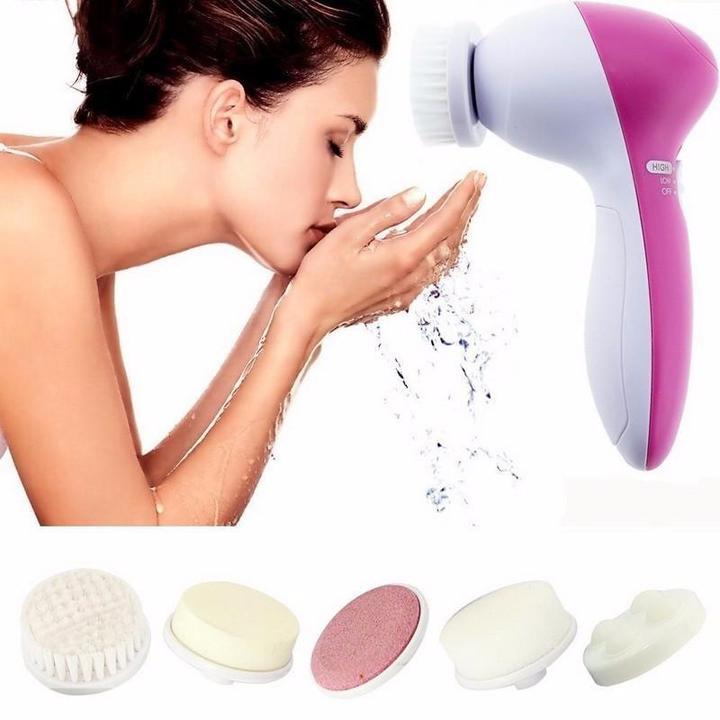 Pink and white 5 in 1 electric facial cleansing brush set with interchangeable scrubbing heads for deep skin cleaning